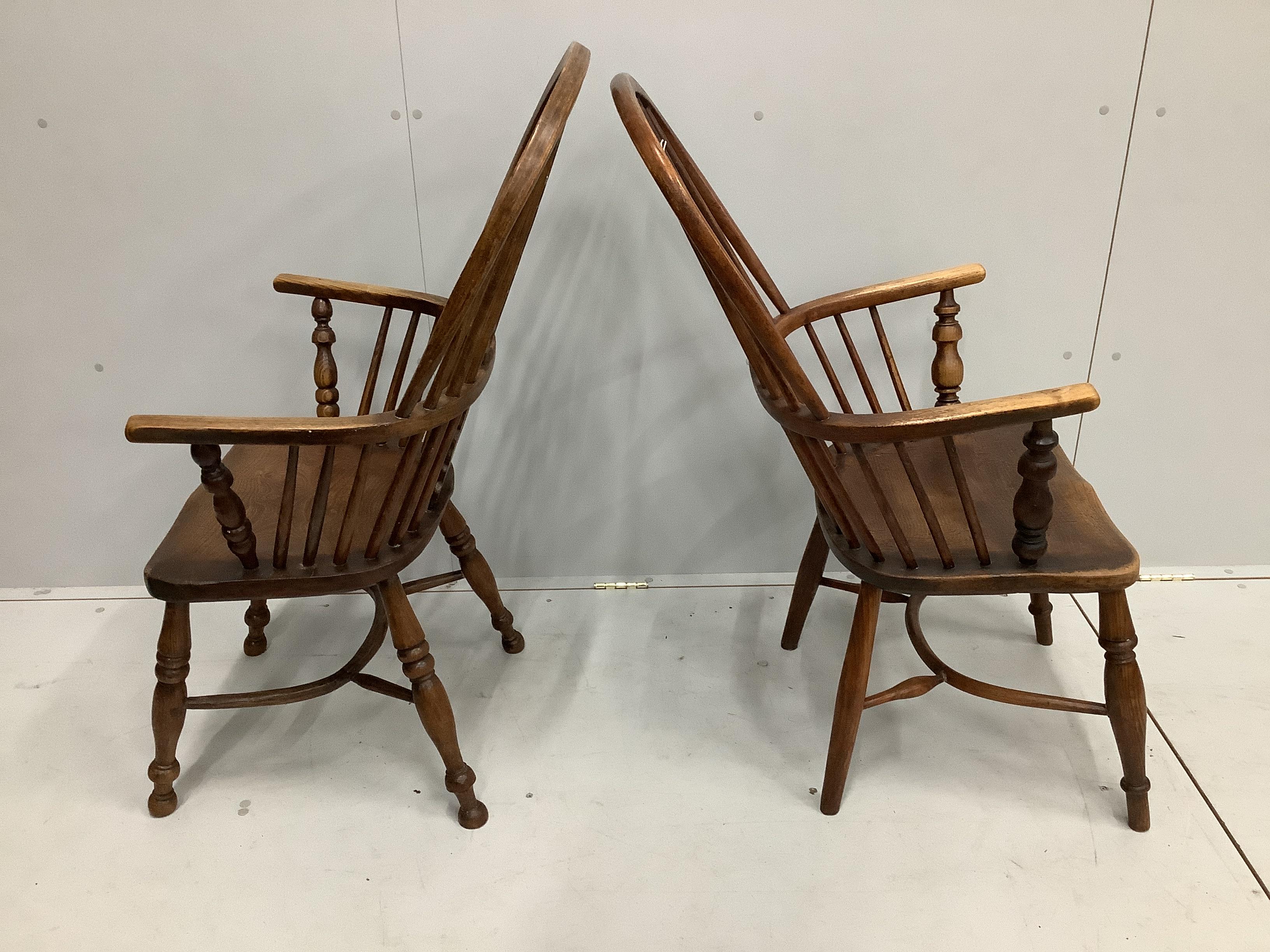 A near pair of mid 19th century Nottingham area ash and elm Windsor armchairs, larger width 53cm, depth 40cm, height 112cm